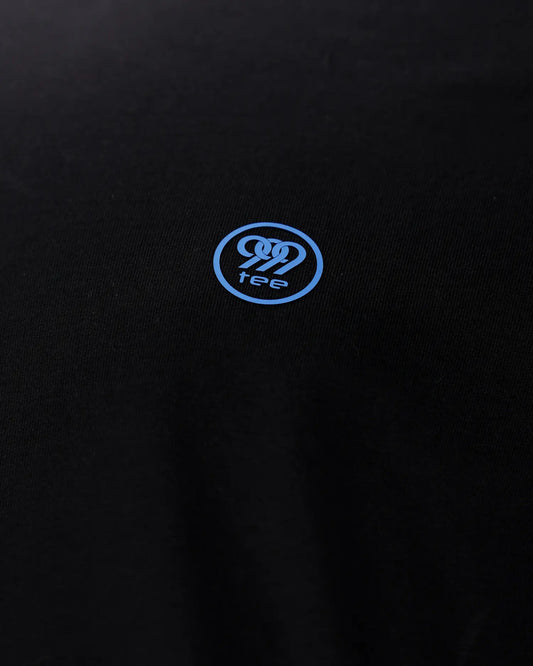 Close-up of blue 999tee logo print on black fabric, detail shot