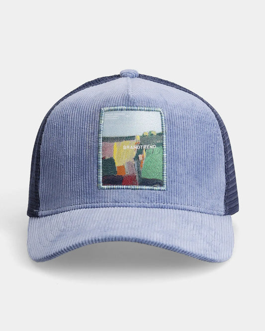 Blue corduroy trucker cap with BRANDTREND artistic patch, front view product shot