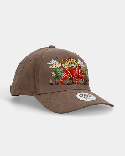 Angled front view of amber claw suede cap with embroidered tiger artwork.