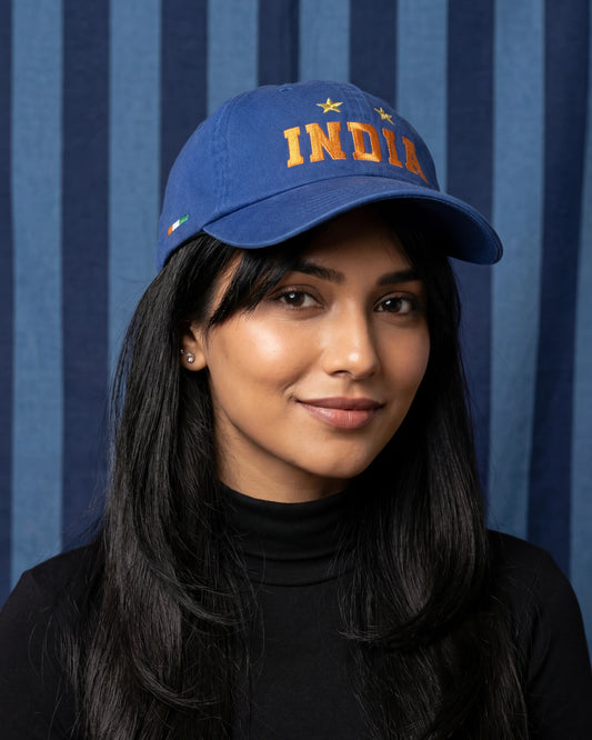 Female model wearing Golden Stars India dad cap, front close-up view