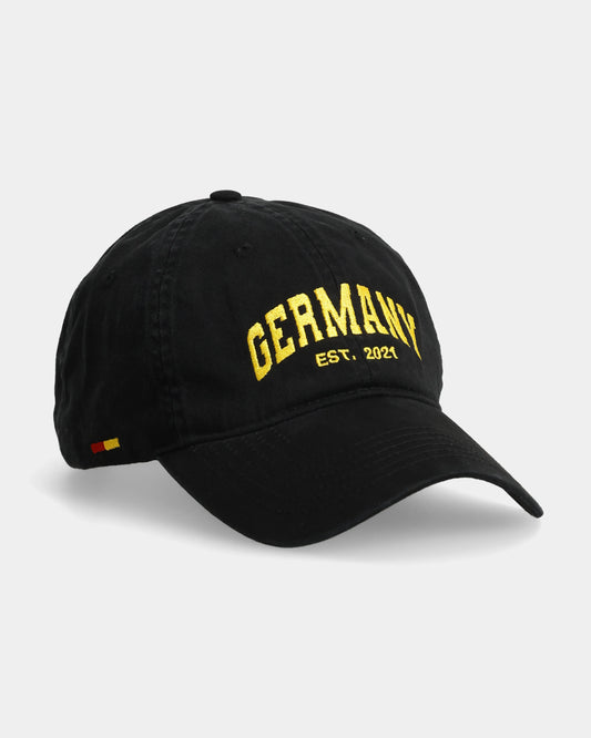 Black cap with ‘Germany EST. 2021’ embroidered in yellow on the front.