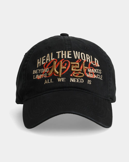 Black dad cap with ‘Heal the World’ and multicoloured embroidered text.