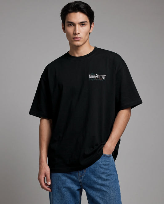 Male model wearing Cosmic Odyssey T-shirt with nine9ninet text, front view