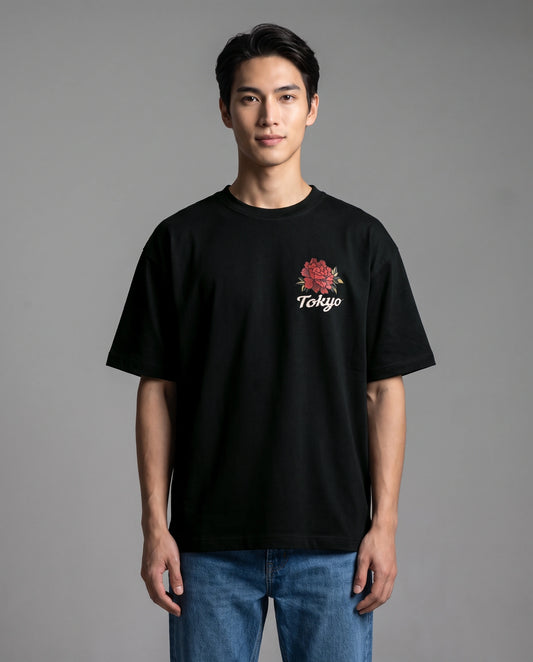 Male model wearing black T-shirt with Tokyo floral chest graphic, front view