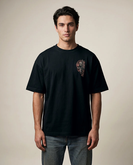 Male model wearing black T-shirt with Nine9nineT skull chest graphic, front view