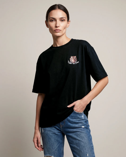 Female model wearing black T-shirt with tiger chest graphic, front view