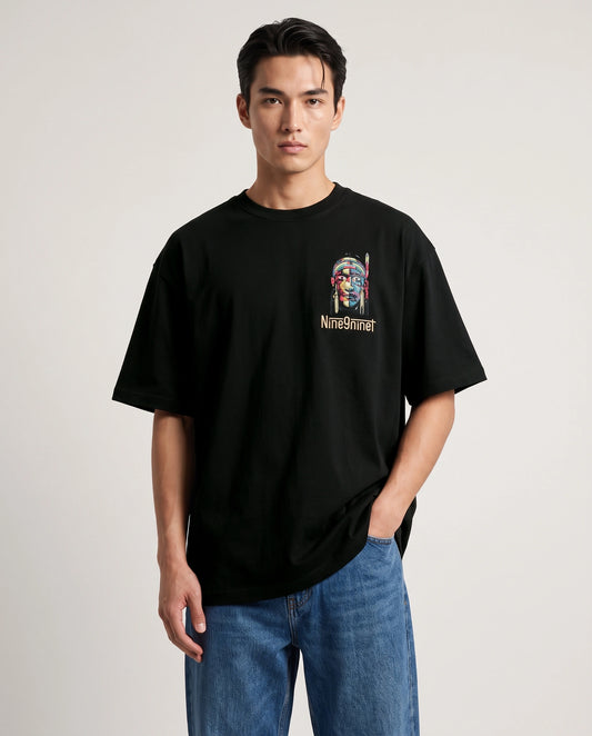 Male model wearing black T-shirt with mask face chest graphic, front view