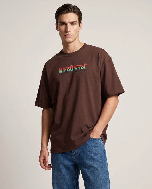 Female model wearing brown Flickers of Hope oversized T-shirt, front view