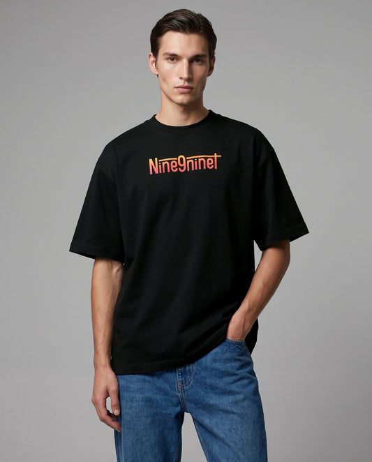 Male model wearing black Born of Flame oversized T-shirt with Nine9nineT text, front view