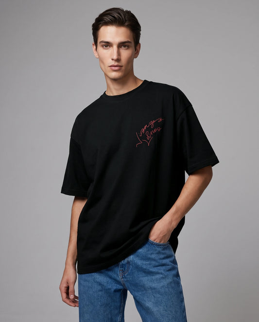 Male model wearing Faces Unbound oversized T-shirt with chest text graphic, front view