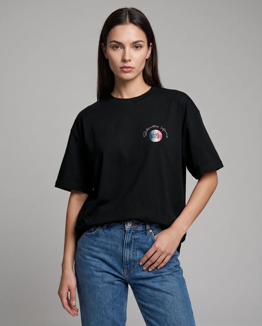 Female model wearing black oversized t-shirt with Ninety9 chest logo, front view