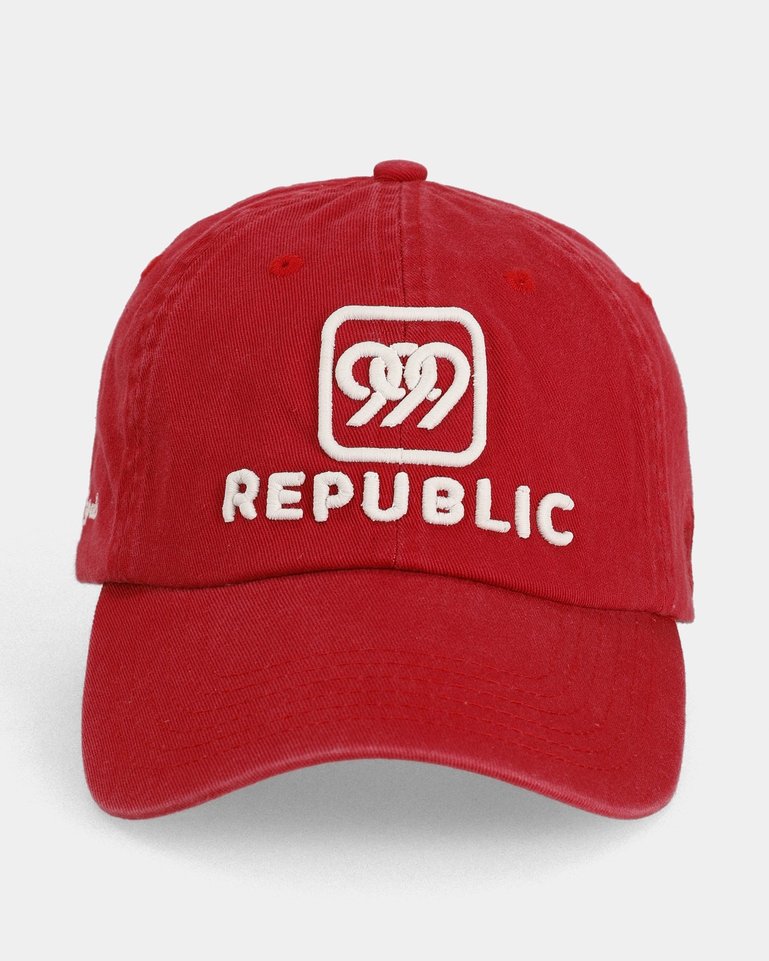 Red dad cap front view with white Republic embroidered front detail