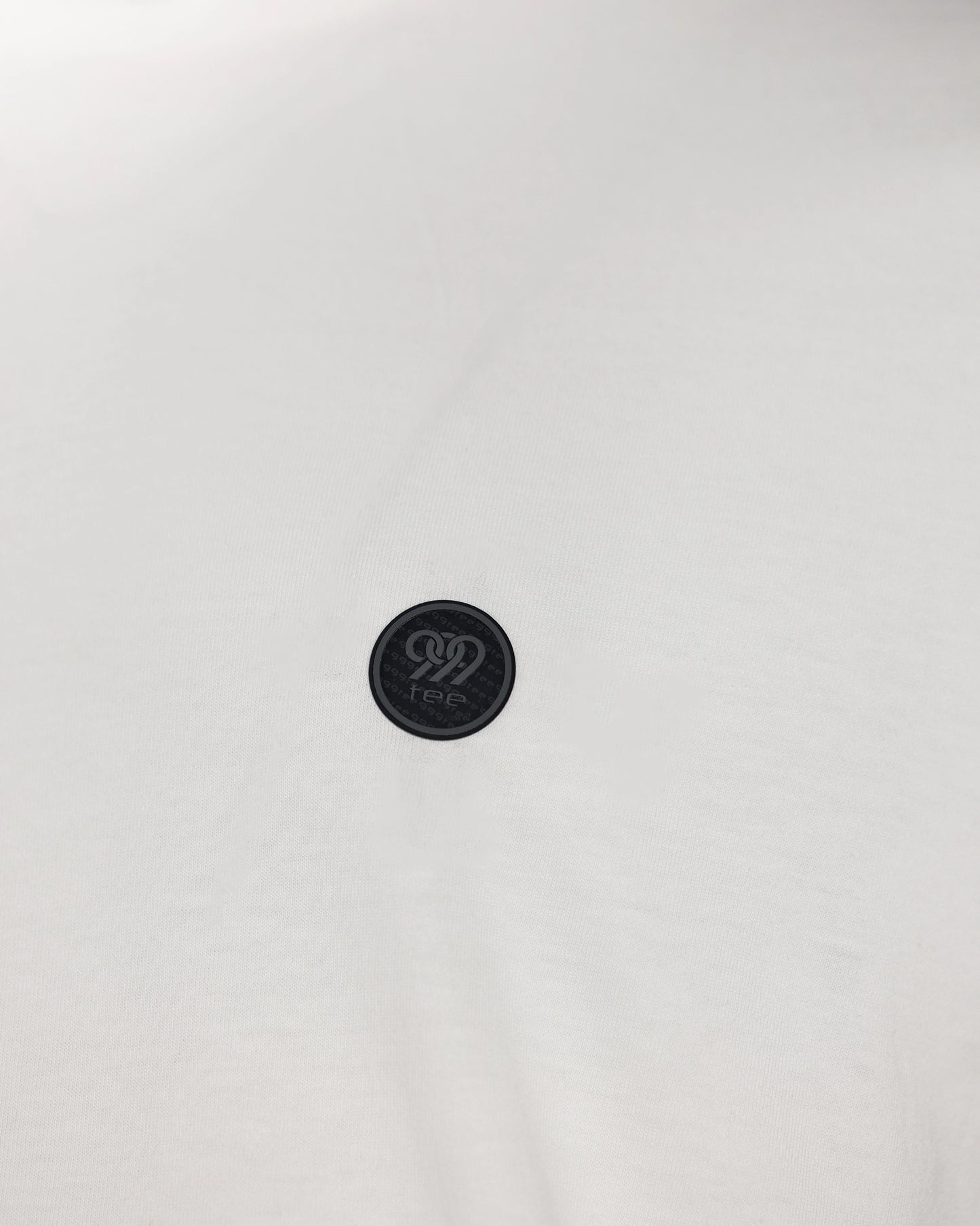 Close-up of round logo patch on light fabric, detail shot
