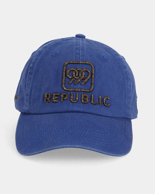 Blue dad cap with REPUBLIC embroidery in multi brown thread, front view
