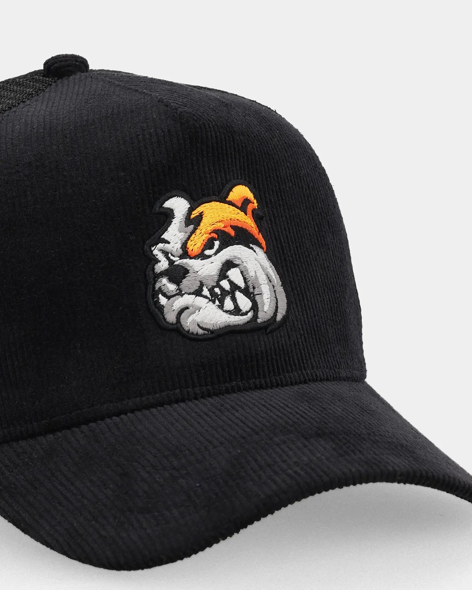 Bulldog Grit trucker cap close-up with bulldog embroidery detail
