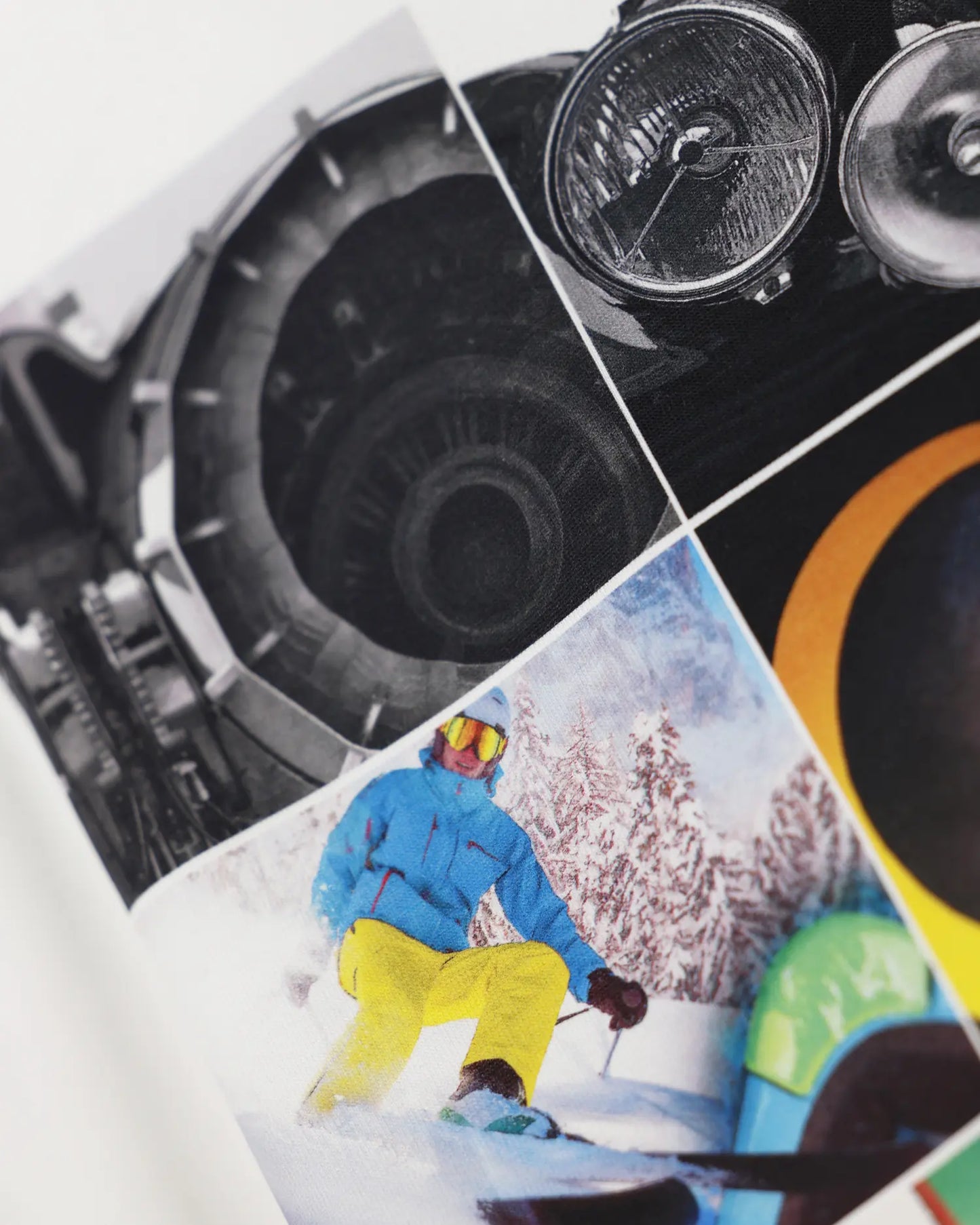 White apparel with collage print featuring skier and vintage car, close-up detail