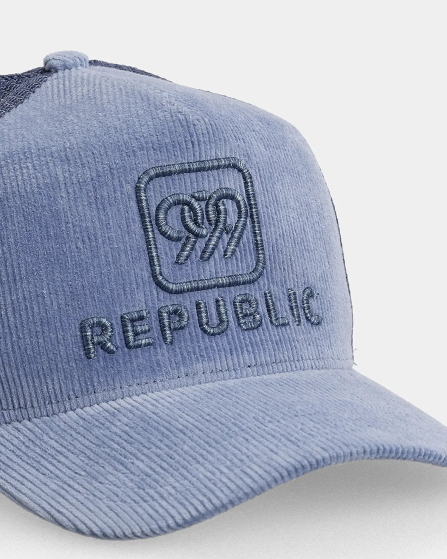 Blue Republic trucker cap close-up with embroidered front text detail