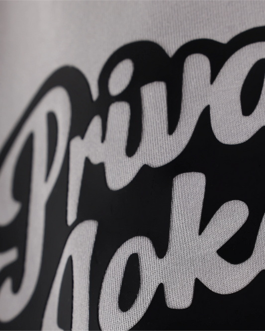 lavender dust T-shirt with Private Jokes Only text, angled close-up detail view