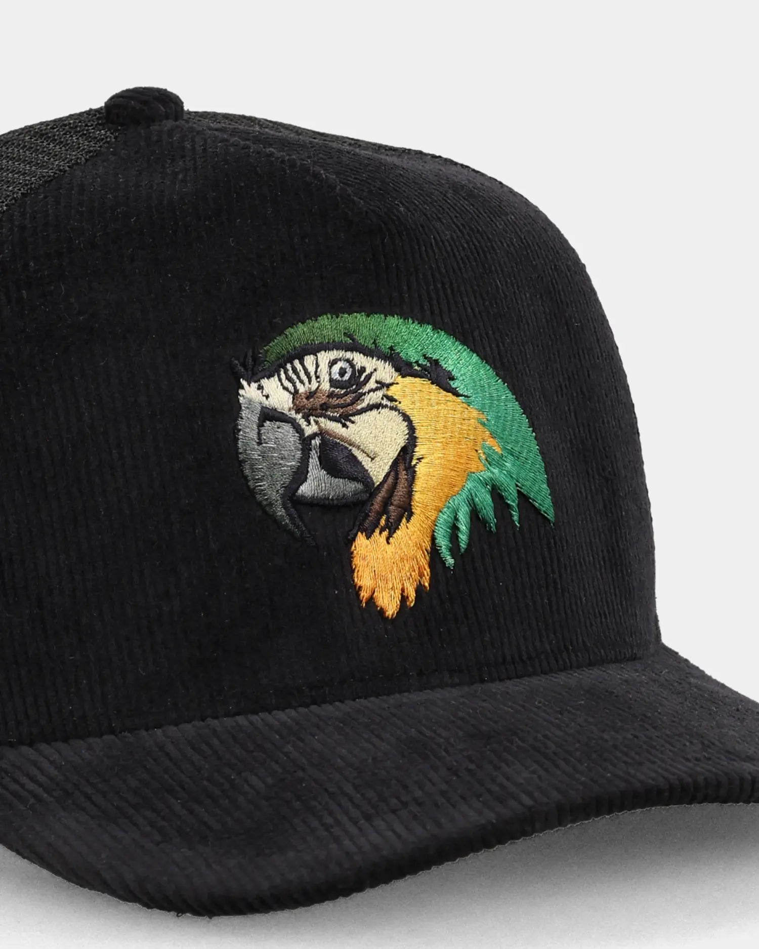 Black trucker cap with parrot embroidery, angled front detail view- tropical breeze
