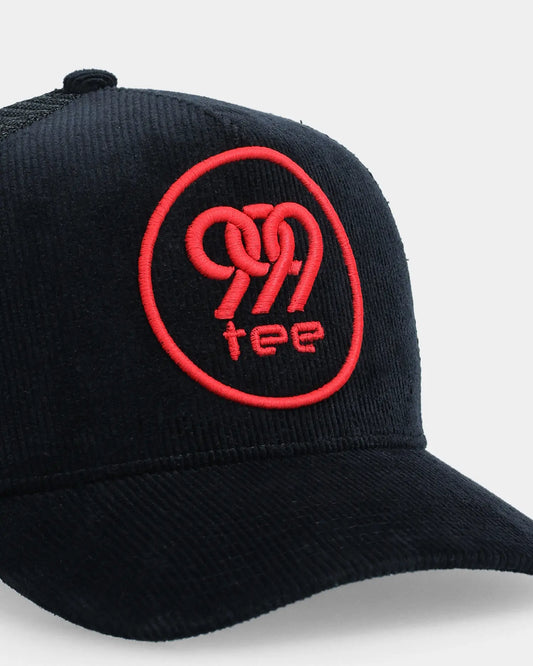 Black corduroy trucker cap with red 999tee logo embroidery, angled close-up product shot
