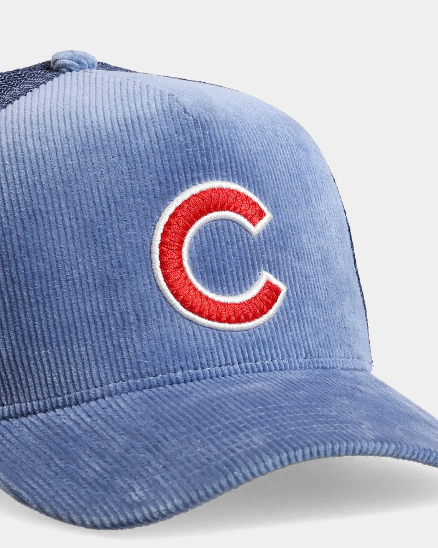 Blue trucker cap close-up with C embroidered front detail