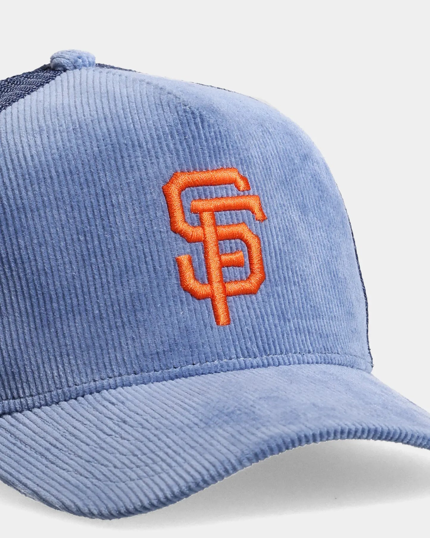 Blue trucker cap close-up with SF embroidered front detail