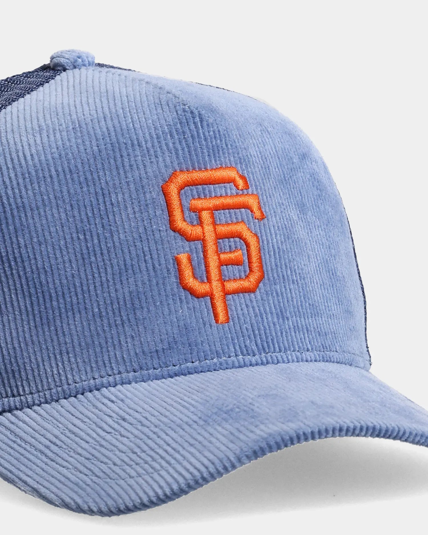 Blue trucker cap close-up with SF embroidered front detail