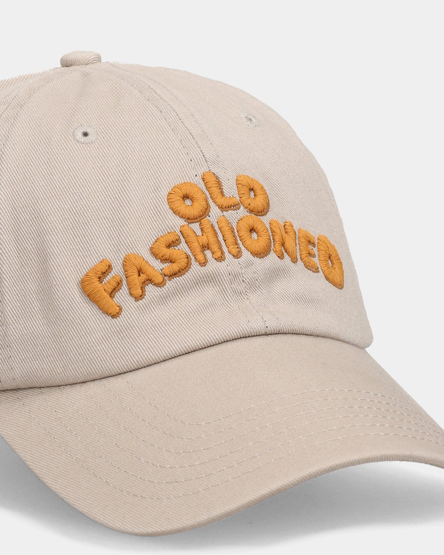 Khaki dad cap with OLD FASHIONED embroidery, close-up front view
