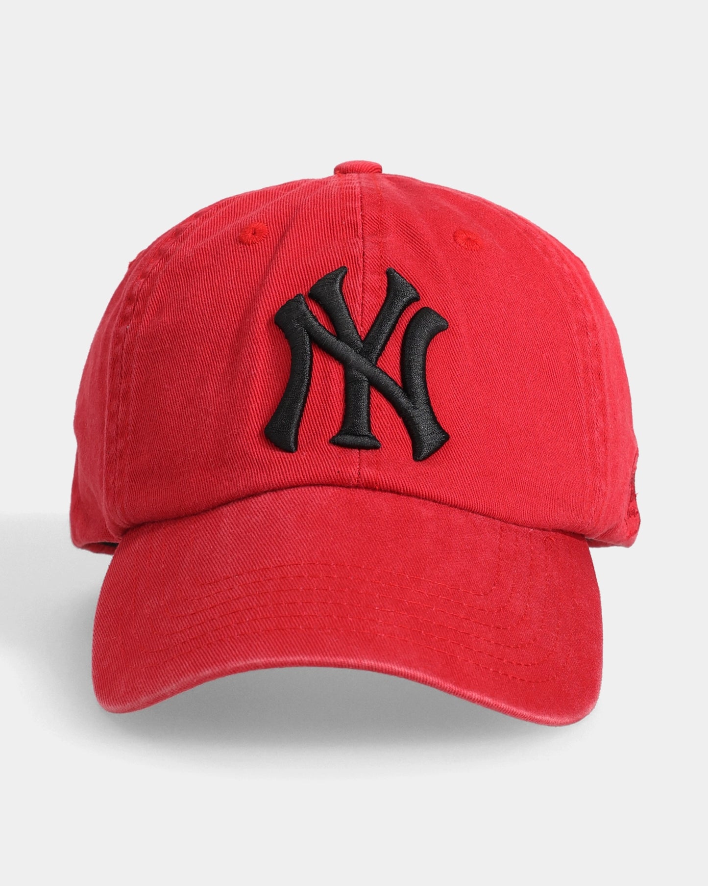 Red cap with black 3D NY embroidery, front view.
