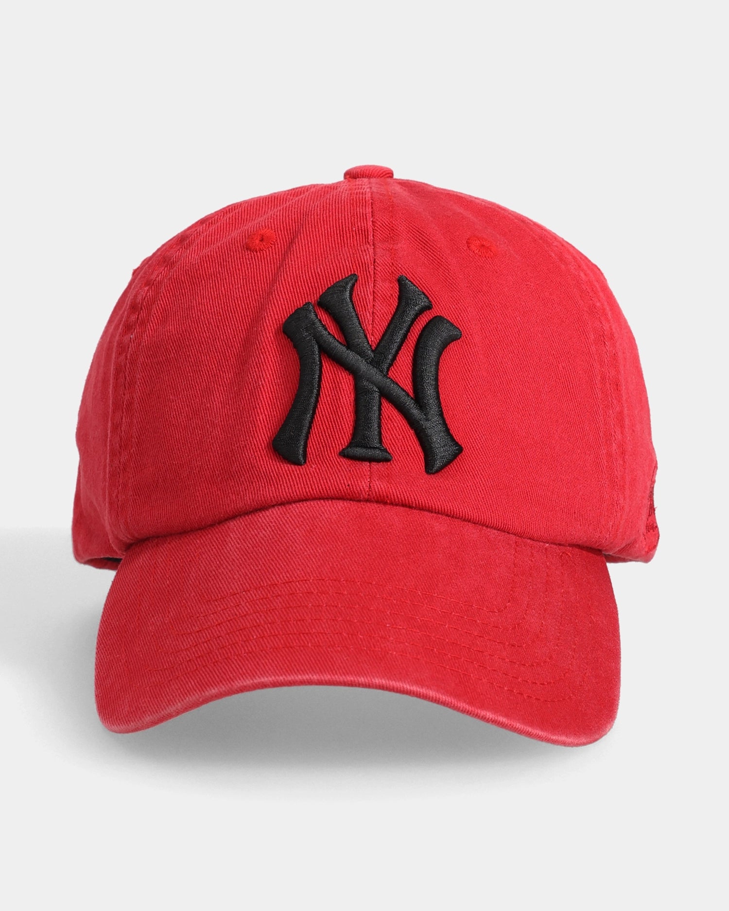 Red cap with black 3D NY embroidery, front view.
