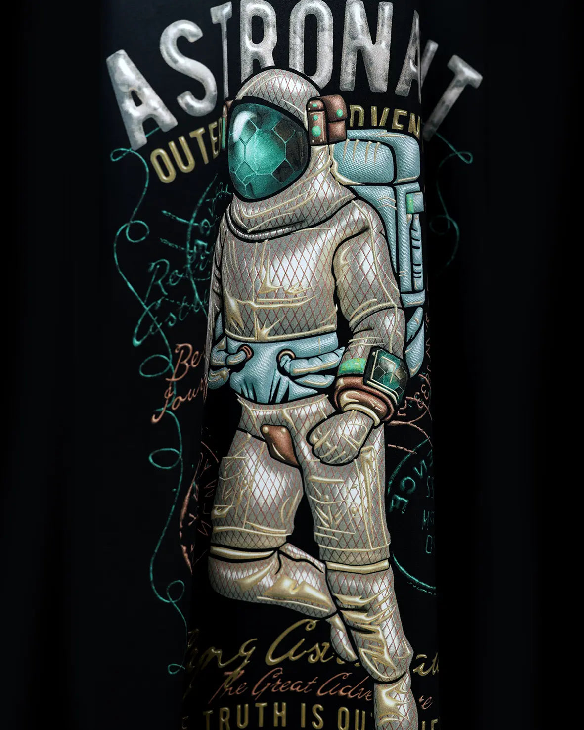 Astronaut graphic with ASTRONAUT text on dark apparel, close-up detail view
