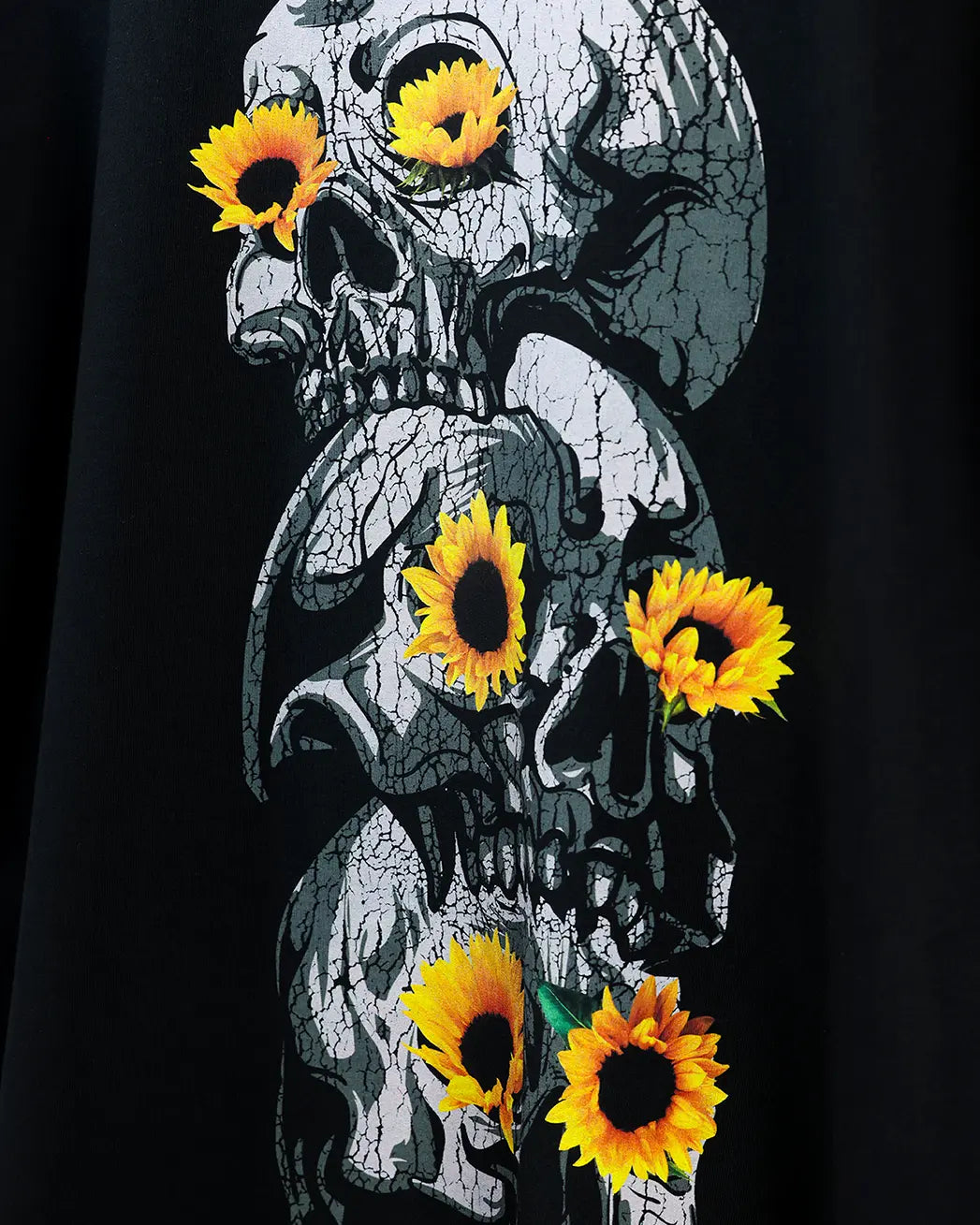 Black T-shirt with skull and sunflower graphic, close-up detail view
