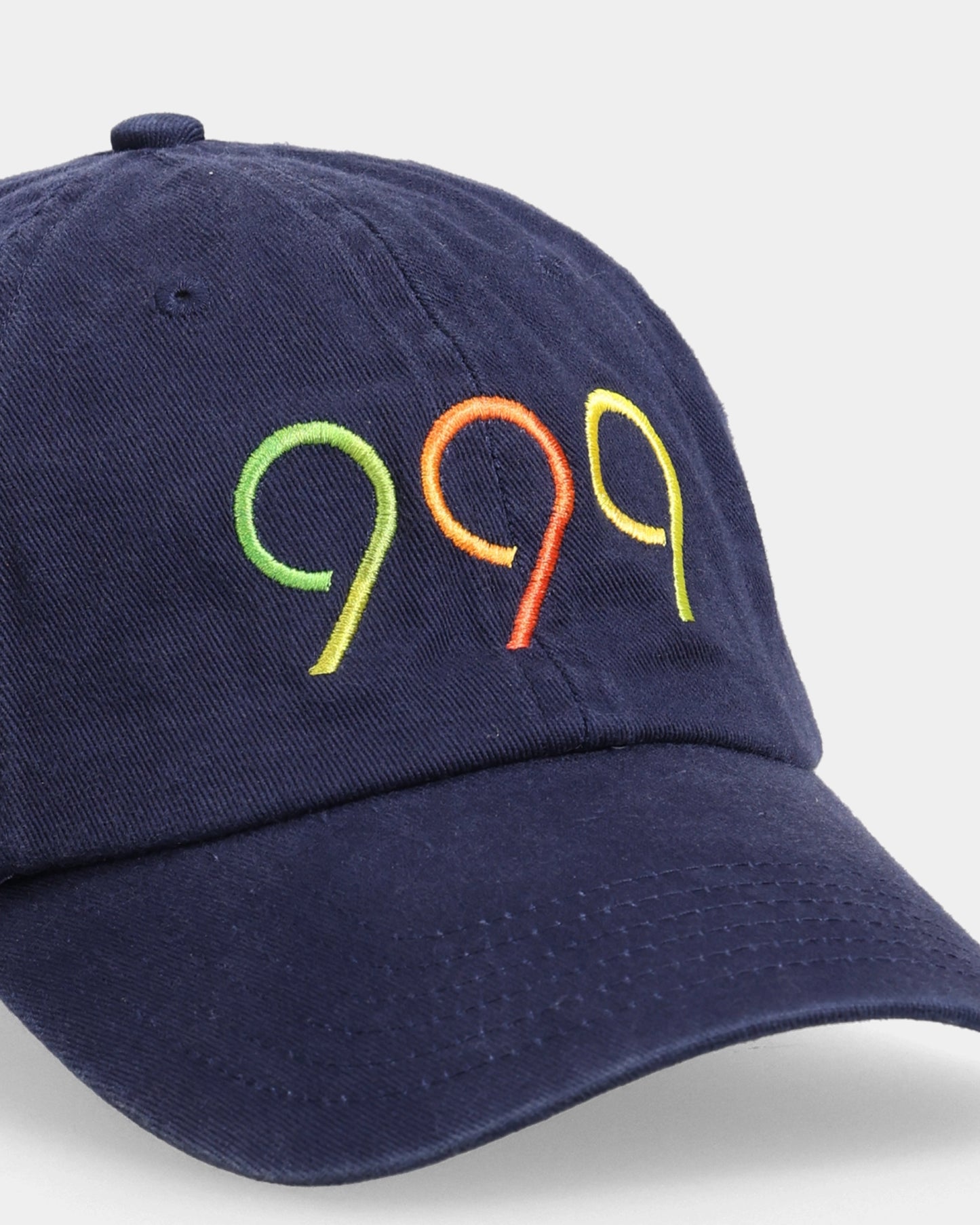 Navy dad cap with multicolour 999 embroidery, front close-up
