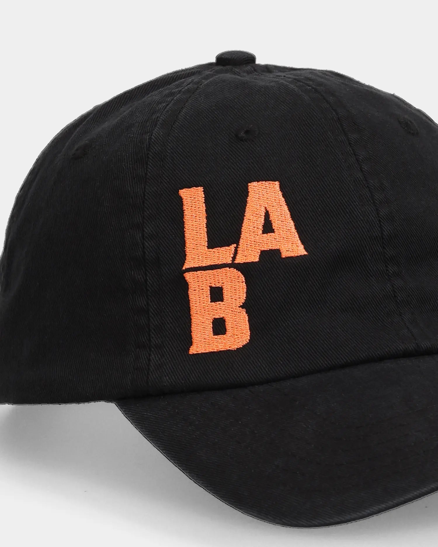 Black dad cap with orange LAB embroidery, angled side product shot
