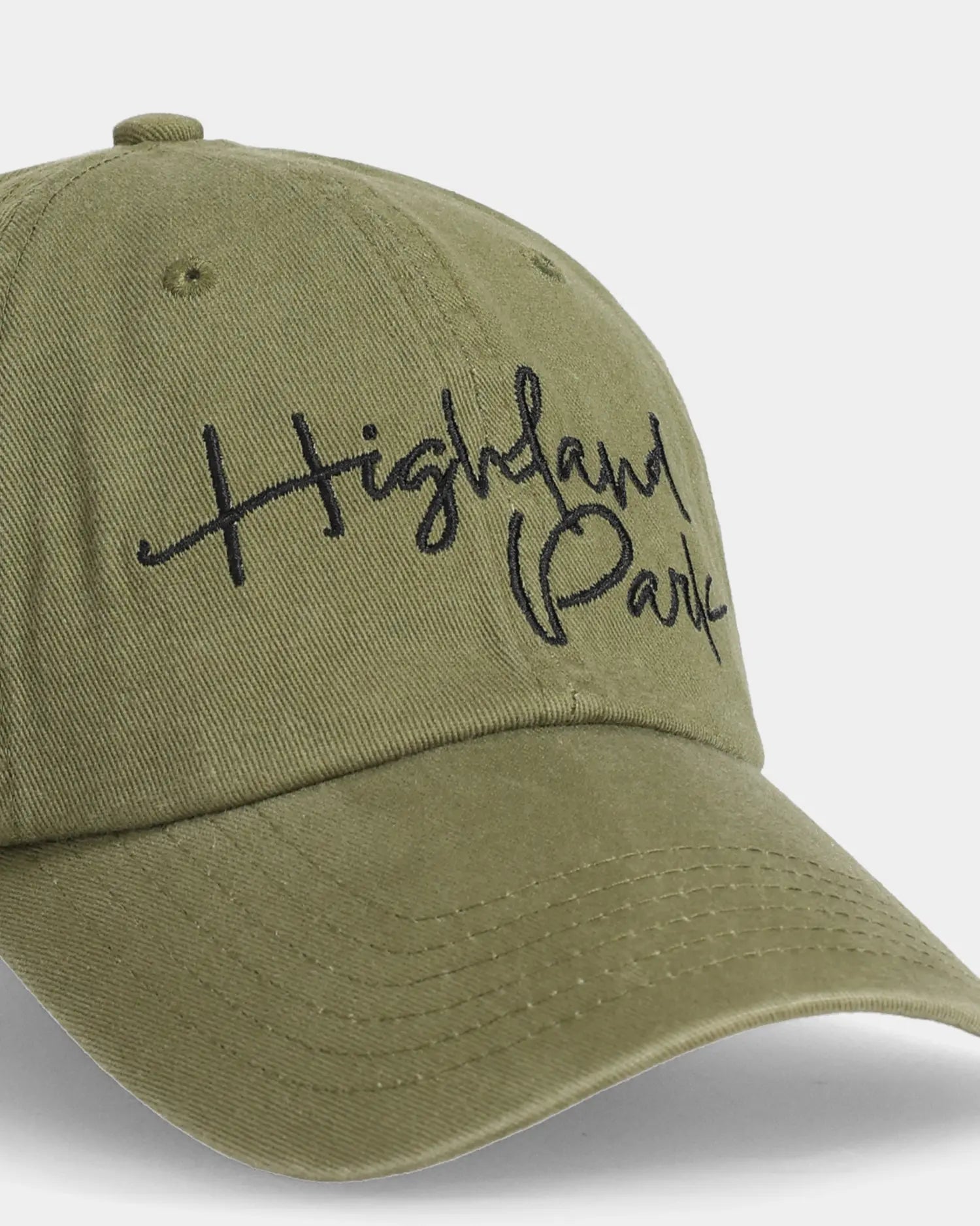 Olive dad cap with Highland Park embroidery, angled front detail view
