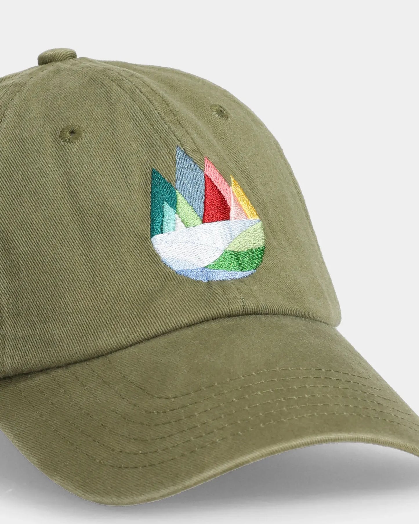 Olive dad cap with mountain embroidery, angled front detail view