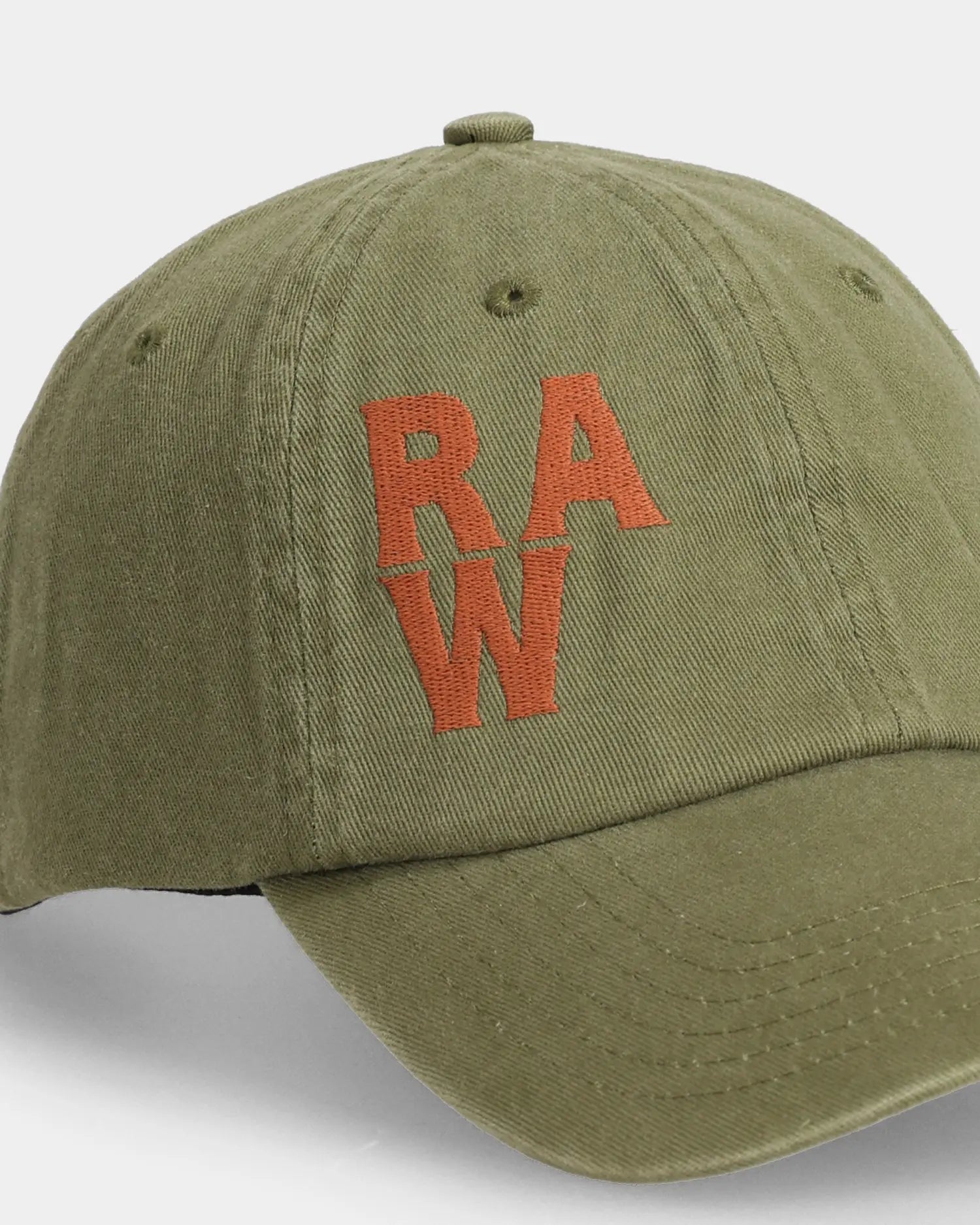 Olive dad cap close-up with orange  RAW embroidered front detail