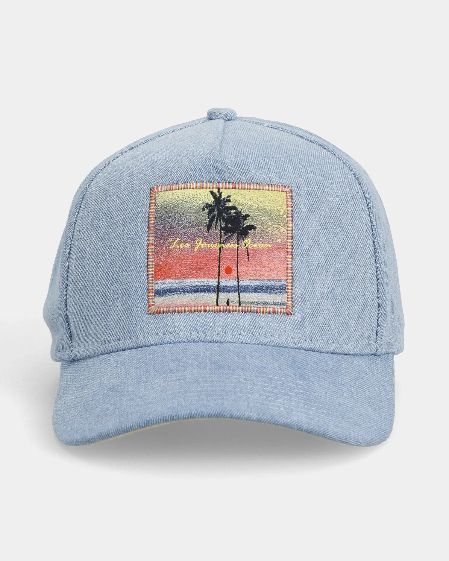 Light blue denim cap front view with ocean scene patch detail