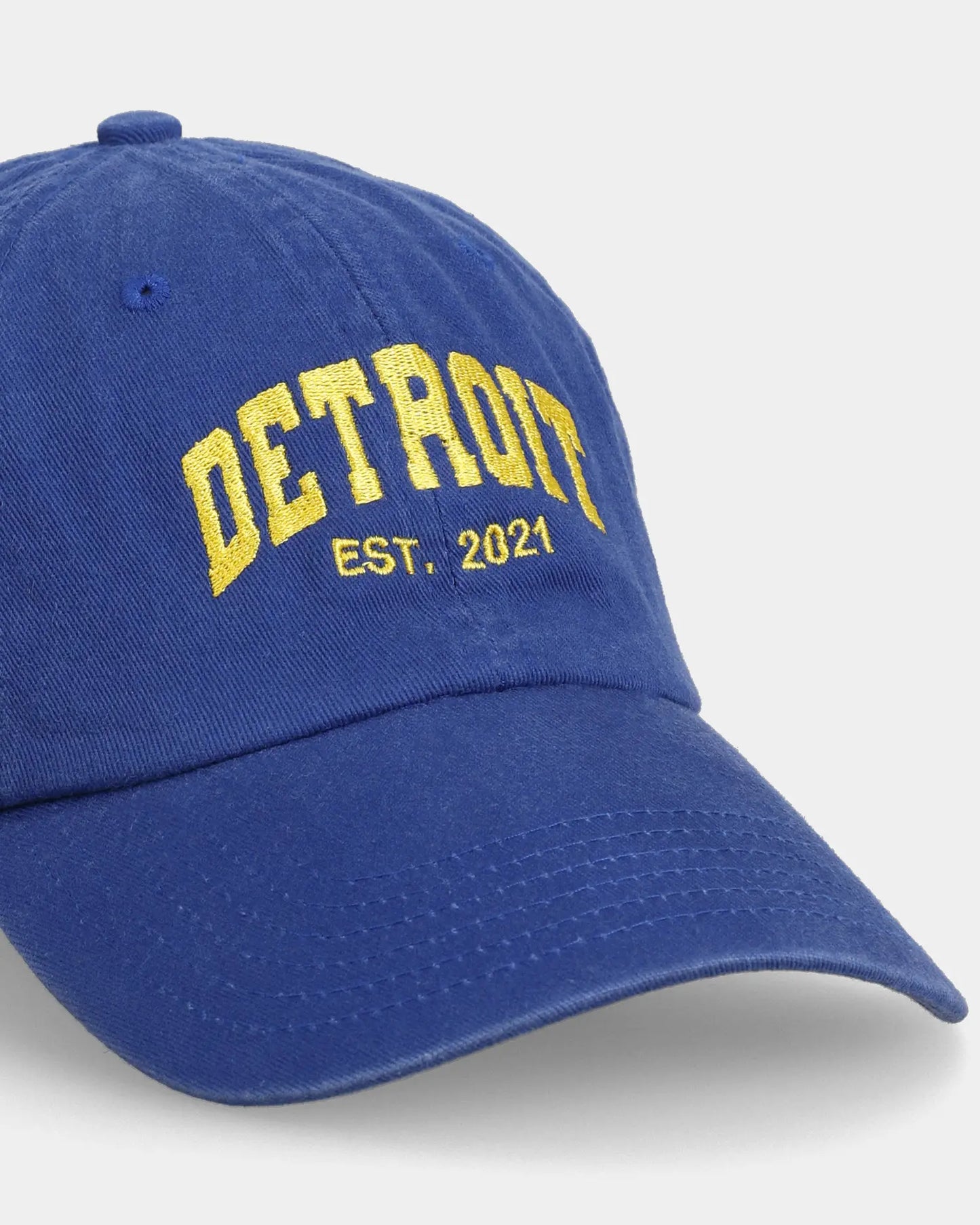 Blue Detroit dad cap close-up with embroidered front text detail
