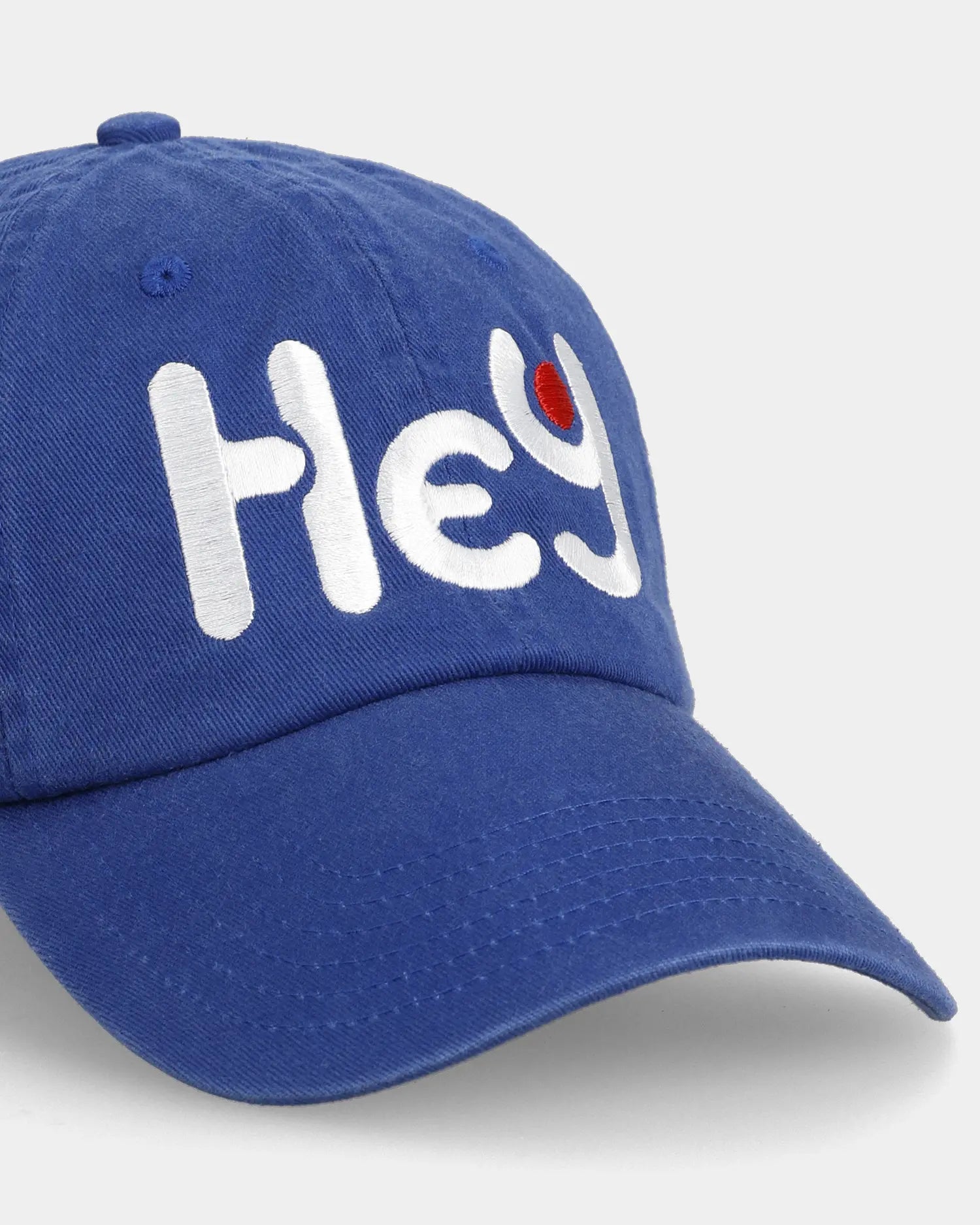 Blue Hey dad cap close-up with embroidered front text detail