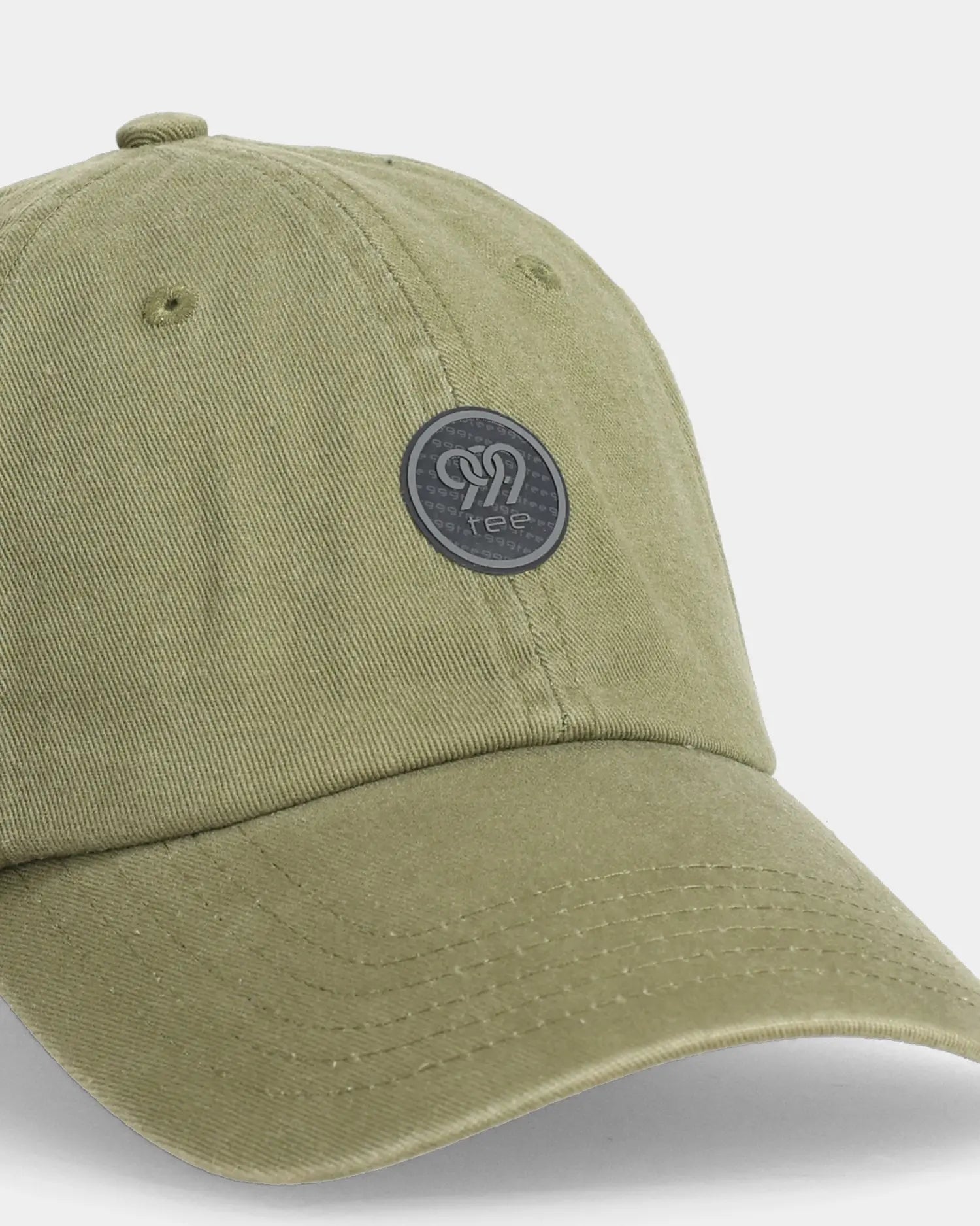 Olive dad cap with round 999tee patch, angled front detail view