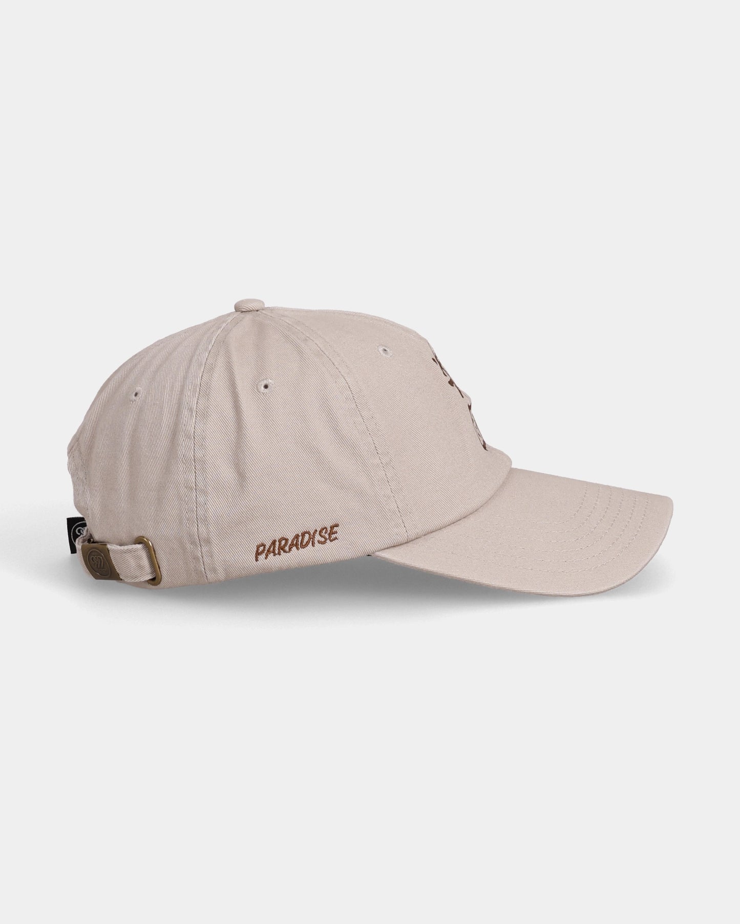 Khaki dad cap with PARADISE side embroidery, left side view product shot
