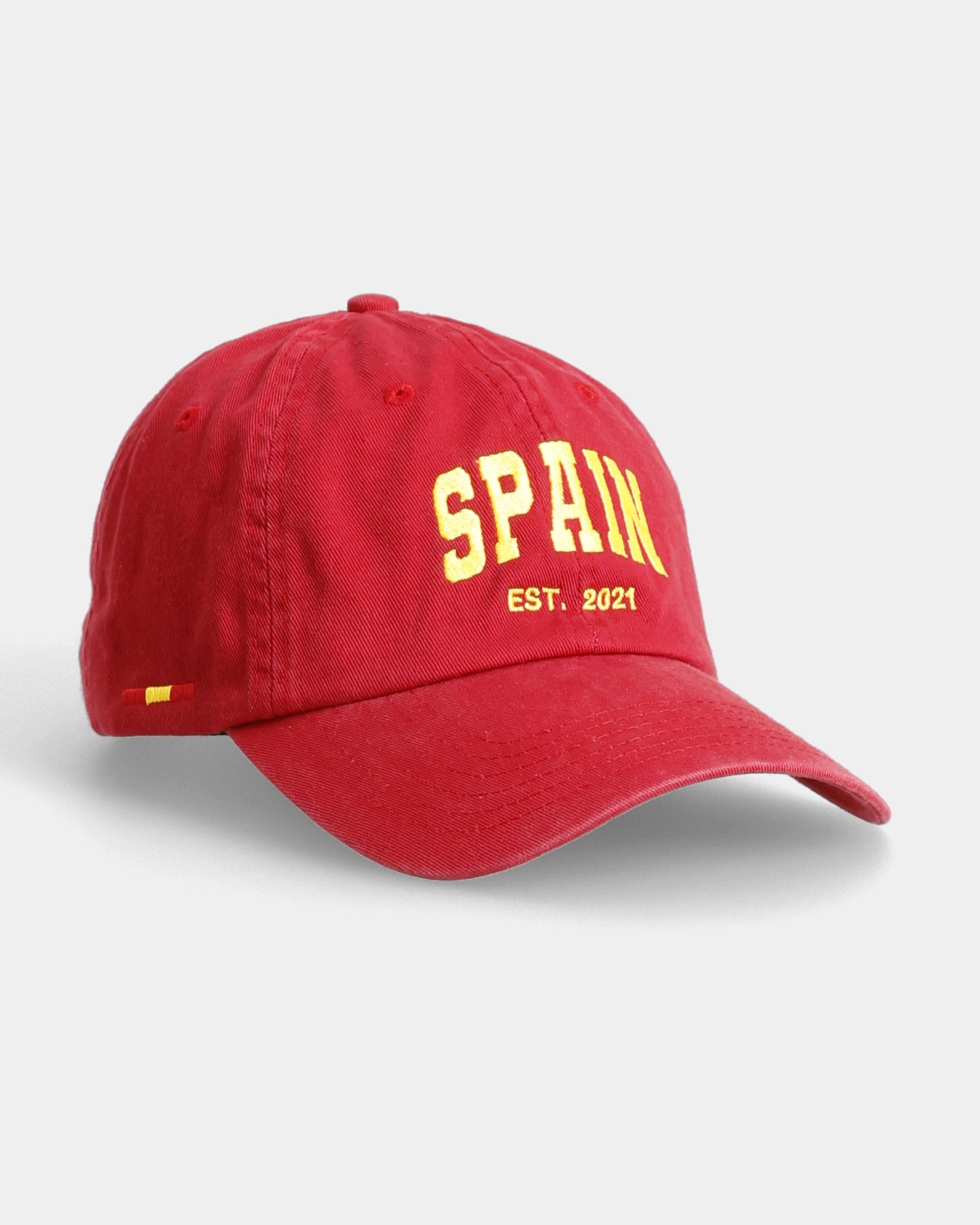 Red Spain dad cap angled front view with embroidered text detail