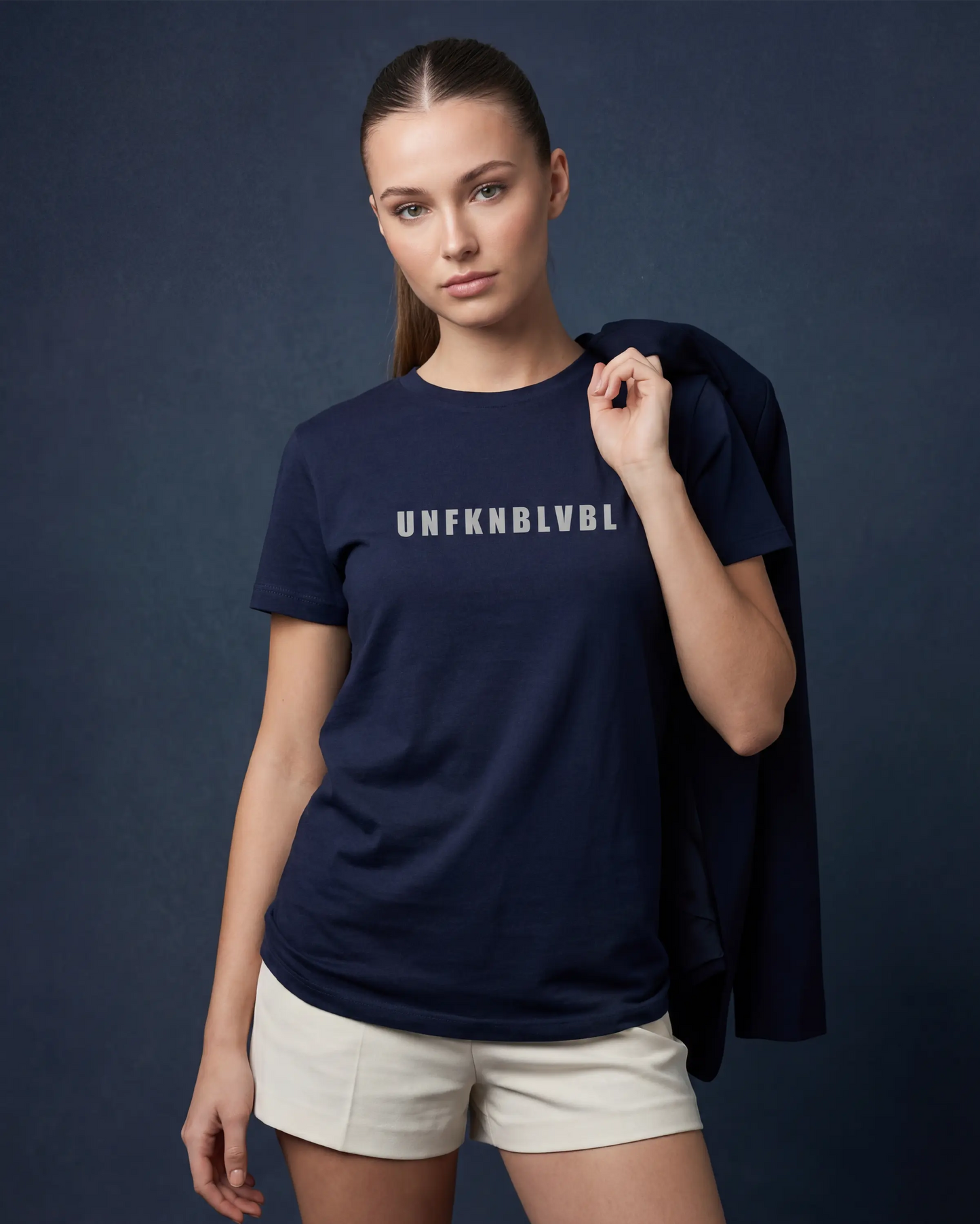 Model wearing denim melange women’s t-shirt with UNFKNBLVBL text, front view model shot