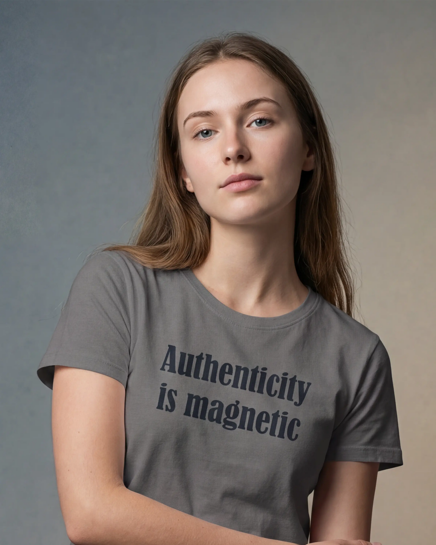 Model wearing an asphalt t-shirt with Authenticity is magnetic text, close-up front view
