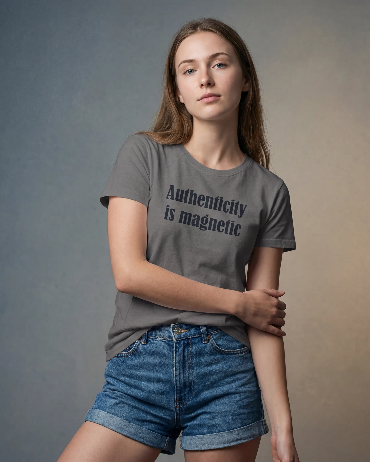Model wearing asphalt t-shirt with Authenticity is magnetic text, front view model shot
