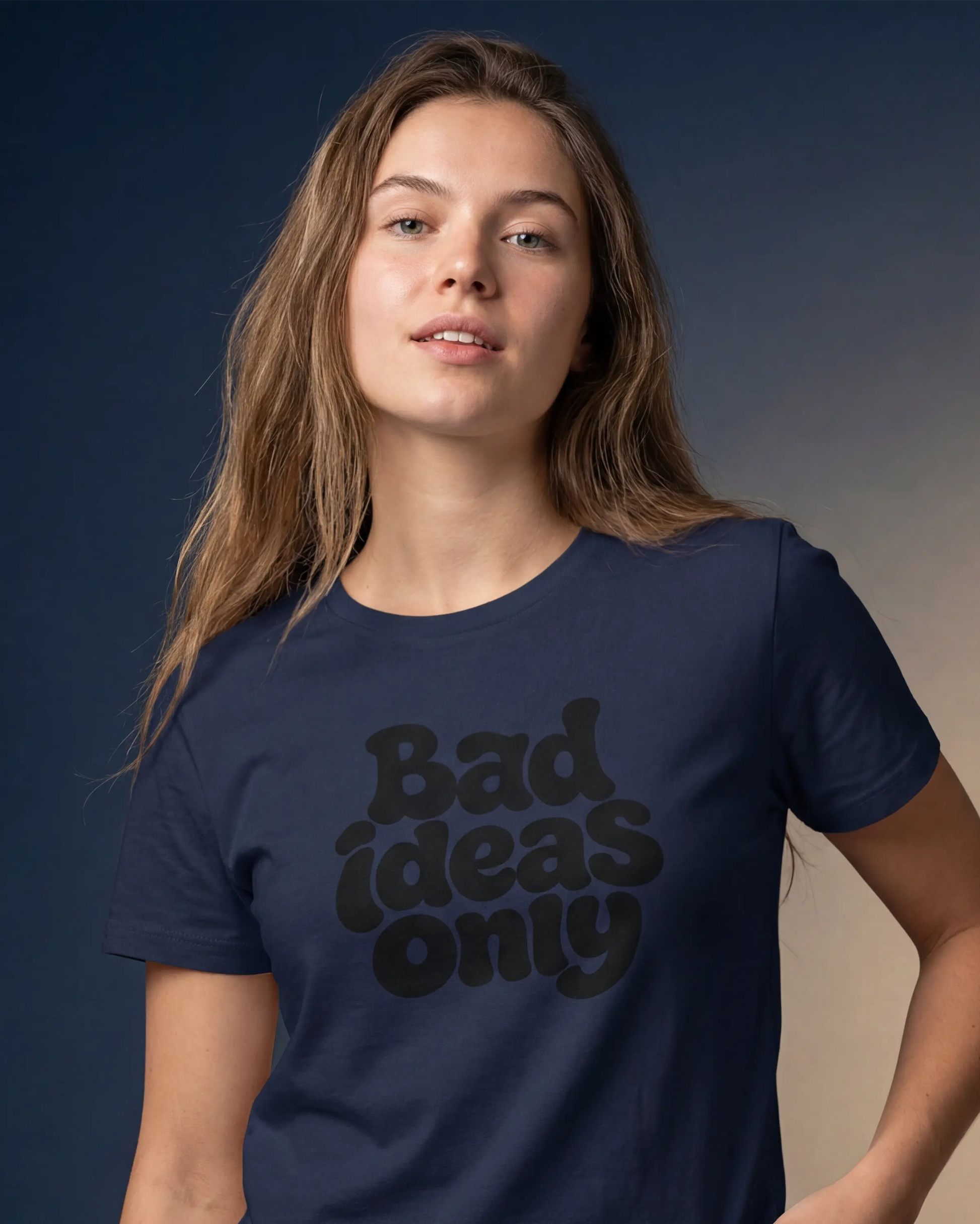 Model wearing a navy t-shirt with Bad ideas only text, close-up front view
