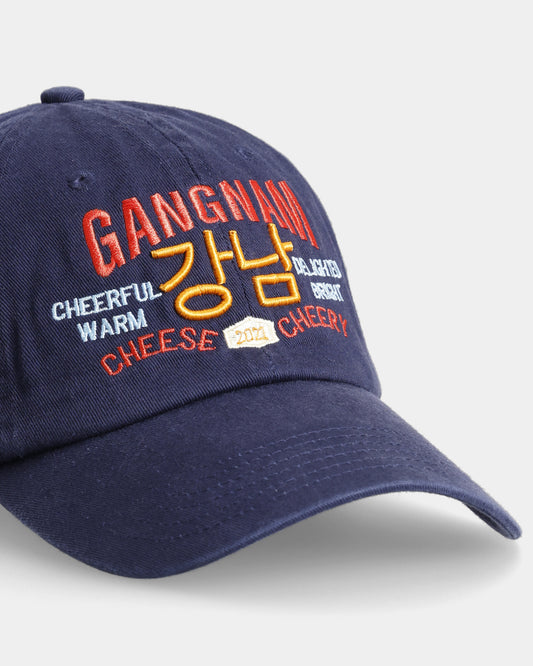 Closeup view of navy cap featuring Gangnam text embroidery.