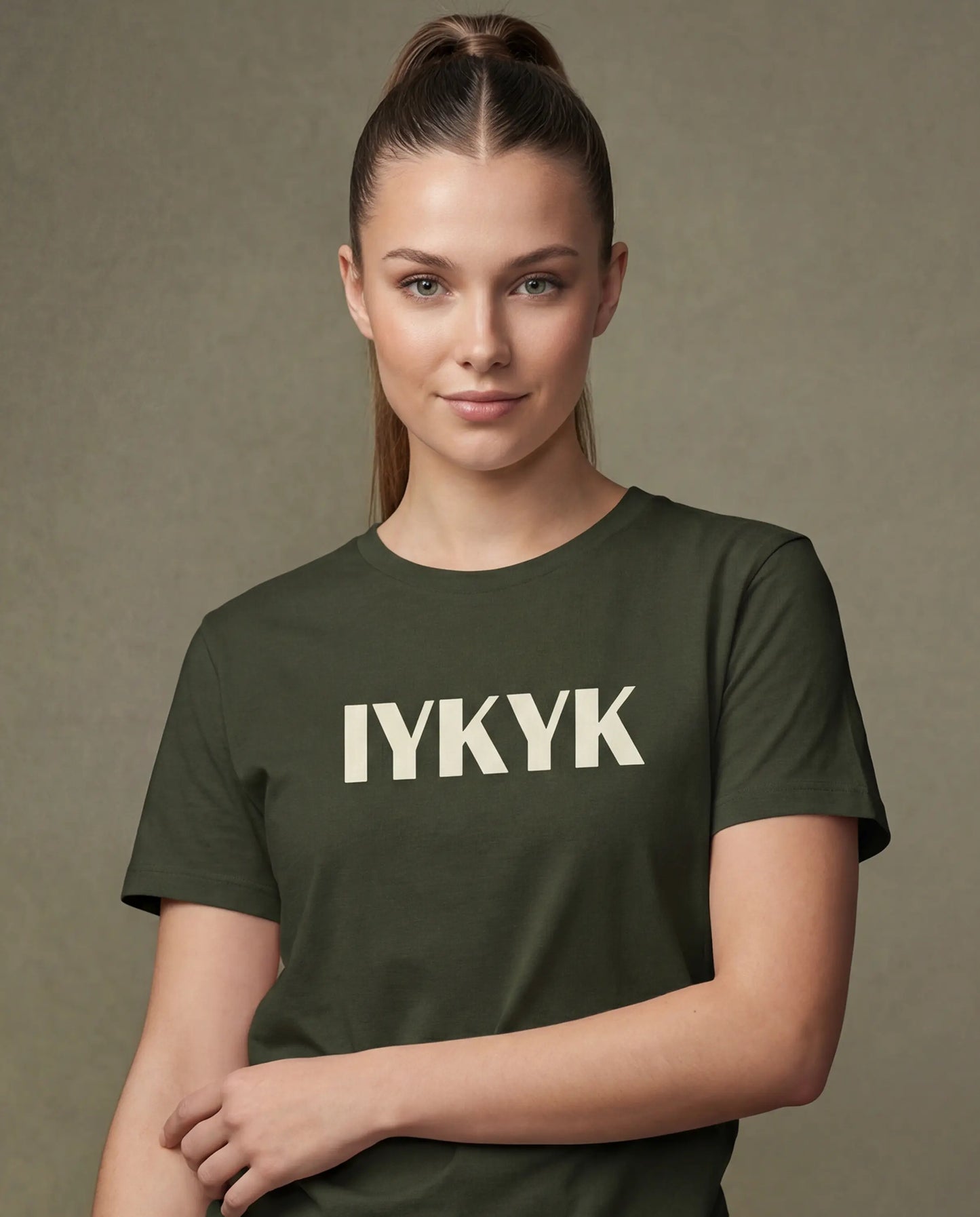 Model wearing olive t-shirt with IYKYK text, close-up front model shot
