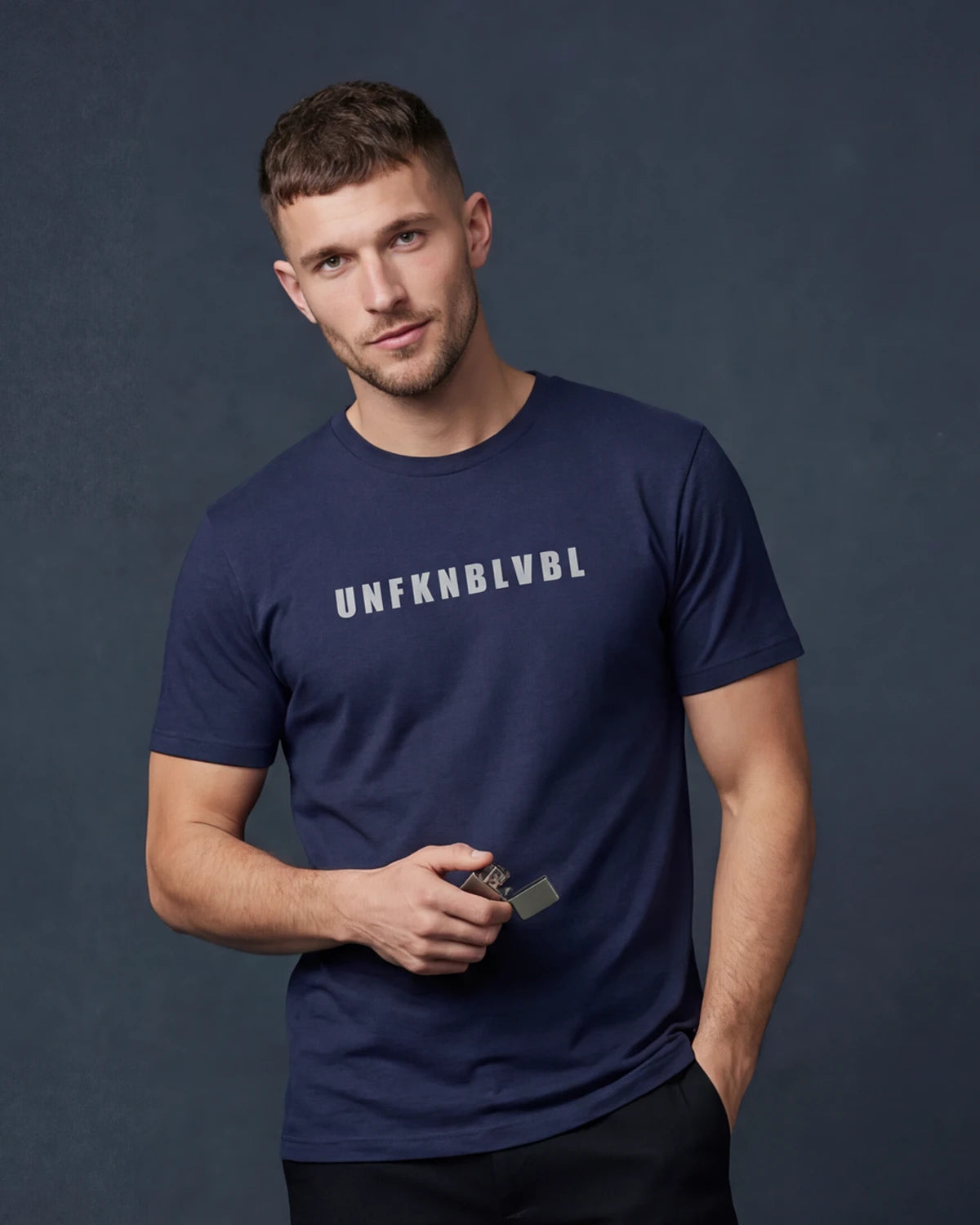 Male model wearing denim melange t-shirt with UNFFKNBLVBL text, front view
